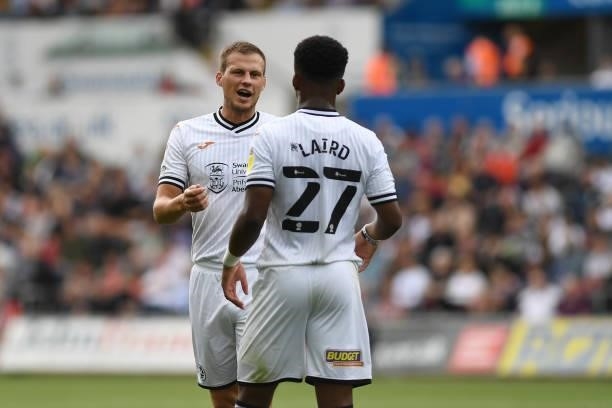Ryan Bennett of Swansea City speaks with team mate Ethan Laird of Swansea City during the Sky Bet Championship match between Swansea City and Hull...