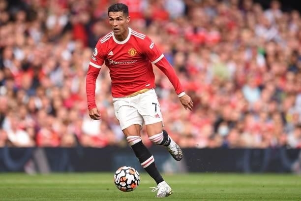 Manchester United's Portuguese striker Cristiano Ronaldo runs with the ball during the English Premier League football match between Manchester...