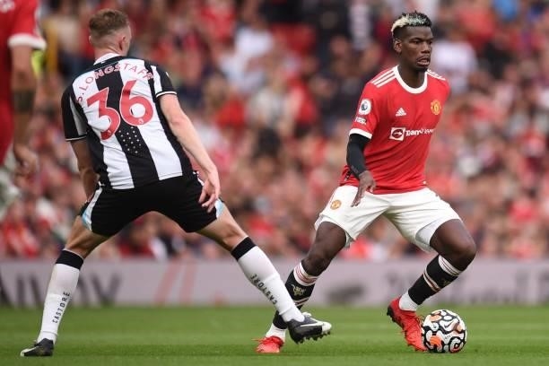 Manchester United's French midfielder Paul Pogba vies with Newcastle United's English midfielder Sean Longstaff during the English Premier League...