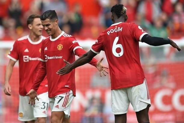 Manchester United's Portuguese striker Cristiano Ronaldo celebrates with Manchester United's French midfielder Paul Pogba after scoring the opening...