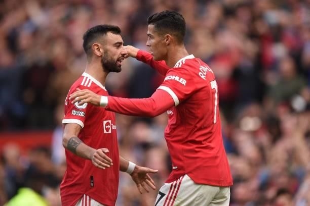 Manchester United's Portuguese striker Cristiano Ronaldo celebrates with Manchester United's Portuguese midfielder Bruno Fernandes after scoring...
