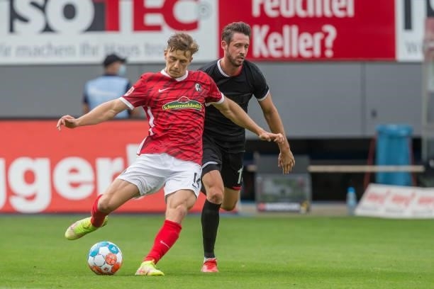 Yannik Keitel of SC Freiburg and Mark Uth of 1.FC Koeln battle for the ball during the Bundesliga match between Sport-Club Freiburg and 1. FC Koeln...