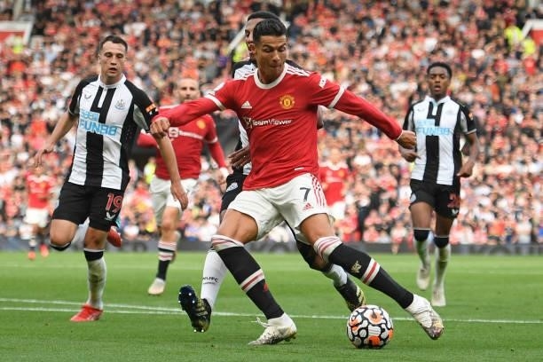Manchester United's Portuguese striker Cristiano Ronaldo shoots to score their second goal during the English Premier League football match between...