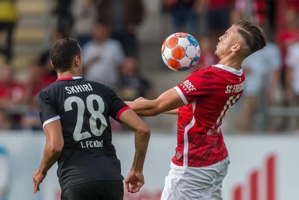 Ellyes Skhiri of 1.FC Koeln and Ermedin Demirovic of SC Freiburg battle for the ball during the Bundesliga match between Sport-Club Freiburg and 1....