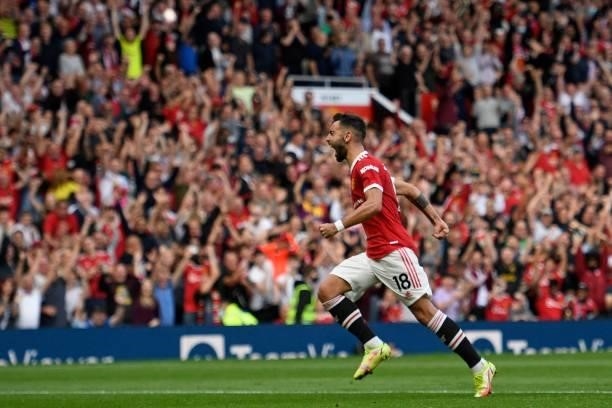 Manchester United's Portuguese midfielder Bruno Fernandes celebrates after scoring their third goal during the English Premier League football match...