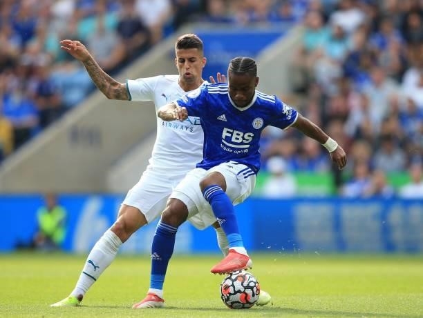 Manchester City's Portuguese defender Joao Cancelo closes in on Leicester City's English midfielder Ademola Lookman during the English Premier League...