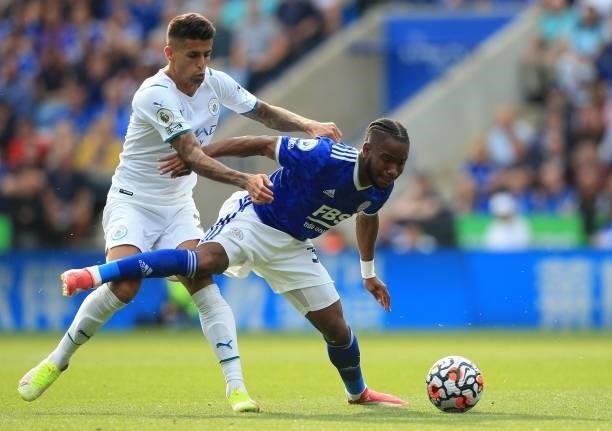 Manchester City's Portuguese defender Joao Cancelo closes in on Leicester City's English midfielder Ademola Lookman during the English Premier League...