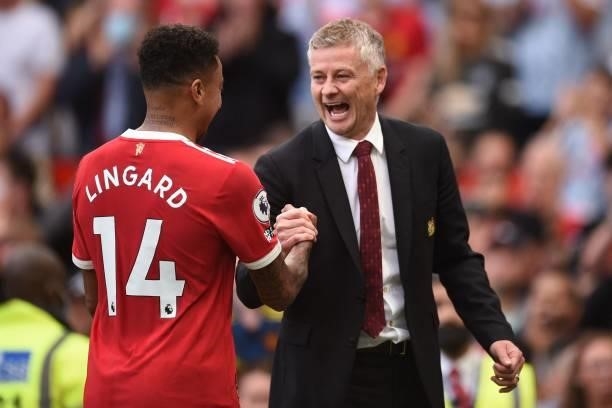 Manchester United's Norwegian manager Ole Gunnar Solskjaer congratulates Manchester United's English midfielder Jesse Lingard after the English...
