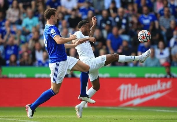 Leicester City's Northern Irish defender Jonny Evans chases Manchester City's English midfielder Raheem Sterling during the English Premier League...