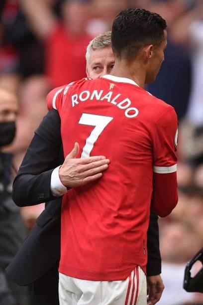 Manchester United's Norwegian manager Ole Gunnar Solskjaer embraces Manchester United's Portuguese striker Cristiano Ronaldo after the English...