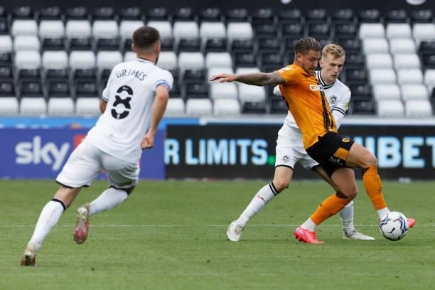Flynn Downes of Swansea City challenges George Moncur of Hull City during the Sky Bet Championship match between Swansea City and Hull City at the...