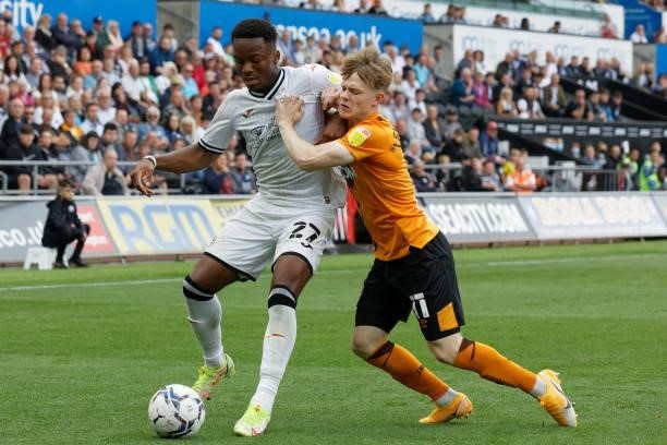 Ethan Laird of Swansea City challenged by Keane Lewis-Potter of Hull City during the Sky Bet Championship match between Swansea City and Hull City at...