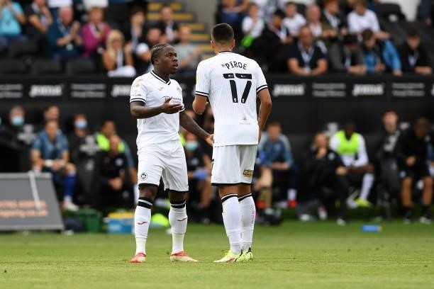 Michael Obafemi of Swansea City speaks with Joël Piroe of Swansea City during the Sky Bet Championship match between Swansea City and Hull City at...