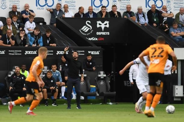 Russell Martin Head Coach of Swansea City shouts instructions to his team from the dug-out during the Sky Bet Championship match between Swansea City...