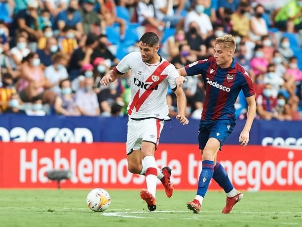 Alejandro Cantero of UD Levante and Santiago Comesana of Rayo Vallecano battle for the ball during the LaLiga Santander match between Levante UD and...