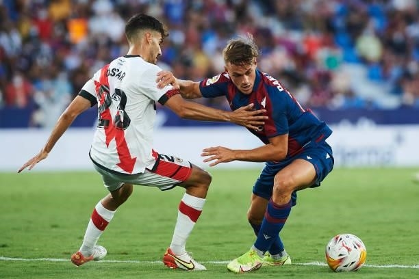 Dani Gomez of UD Levante and Oscar Valentin of Rayo Vallecano battle for the ball during the LaLiga Santander match between Levante UD and Rayo...