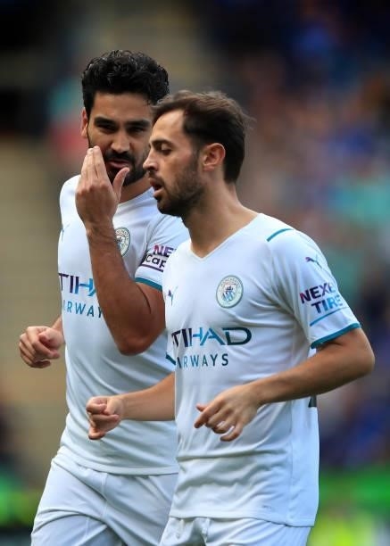 Ilkay Gundogan of Manchester City speaks with teammate Bernardo Silva during the Premier League match between Leicester City and Manchester City at...