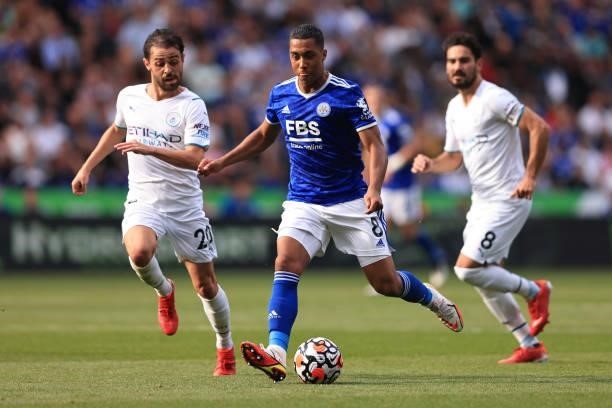 Youri Tielemans of Leicester City in action with Bernardo Silva and Ilkay Gundogan of Manchester City during the Premier League match between...