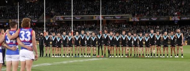 Port Adelaide players line up for the National Anthem during the 2021 AFL Second Preliminary Final match between the Port Adelaide Power and the...