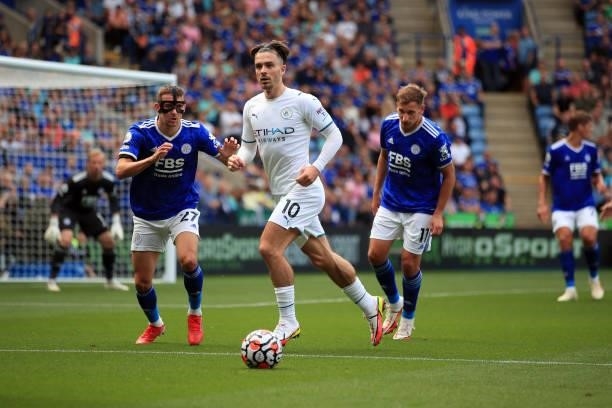 Jack Grealish of Manchester City in action with Timothy Castagne and Marc Albrighton of Leicester City during the Premier League match between...