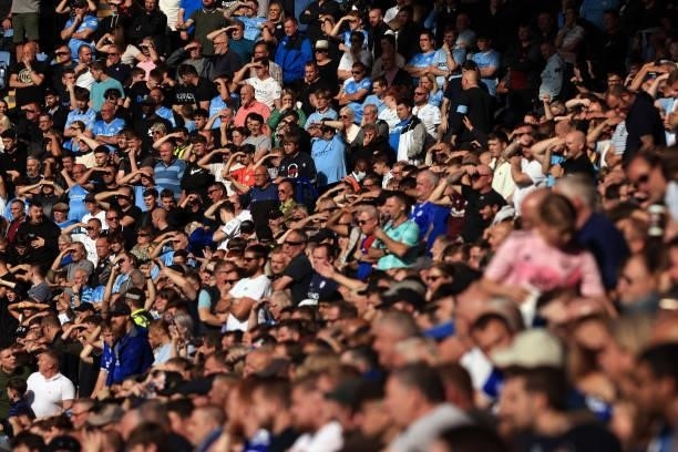 Manchester City fans shield their eyes against the sun during the Premier League match between Leicester City and Manchester City at The King Power...