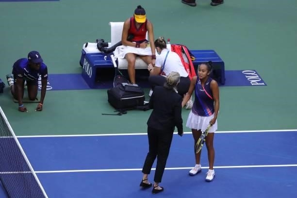 Canada's Leylah Fernandez speaks to an official as Britain's Emma Raducanu has her knee bandaged during their 2021 US Open Tennis tournament women's...