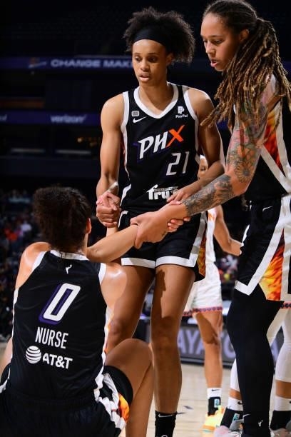 Brianna Turner and Brittney Griner of the Phoenix Mercury help up their teammate during the game against the Connecticut Sun on September 11, 2021 at...