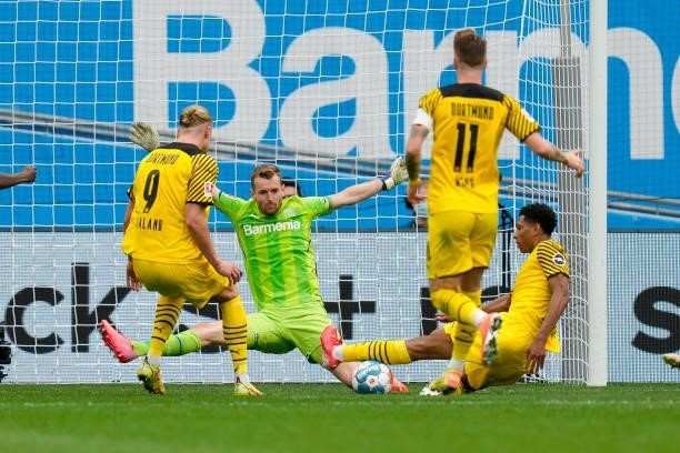 September 11: Erling Haaland of Borussia Dortmund, goalkeeper Lukas Hradecky of Bayer 04 Leverkusen and Jude Bellingham of Borussia Dortmund battle...