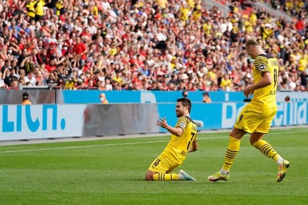 September 11: Raphael Guerreiro of Borussia Dortmund celebrates after scoring his team's third goal during the Bundesliga match between Bayer 04...