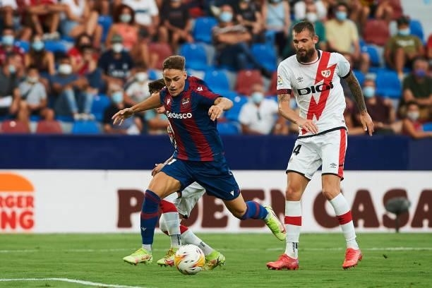 Dani Gomez of UD Levante and Esteban Saveljich of Rayo Vallecano battle for the ball during the LaLiga Santander match between Levante UD and Rayo...