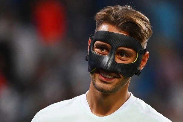 Celta Vigo's Spanish defender Kevin Vazquez wears a face protector as he warms up before the Spanish League football match between Real Madrid CF and...