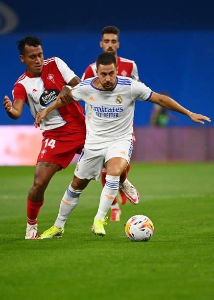 Celta Vigo's Peruvian midfielder Renato Tapia challenges Real Madrid's Belgian forward Eden Hazard during the Spanish League football match between...