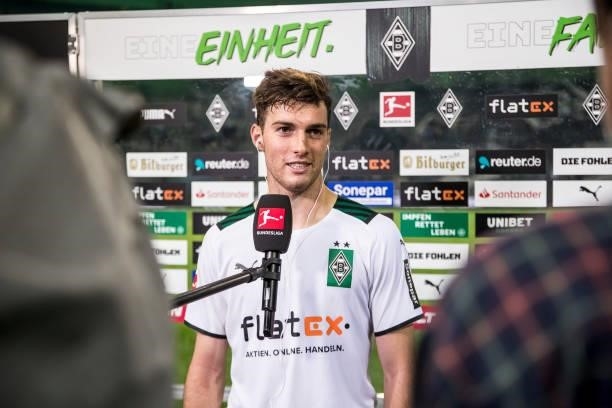 Joe Scally of Borussia Moenchengladbach is interviewed after the Bundesliga match between Borussia Moenchengladbach and Arminia Bielefeld at...