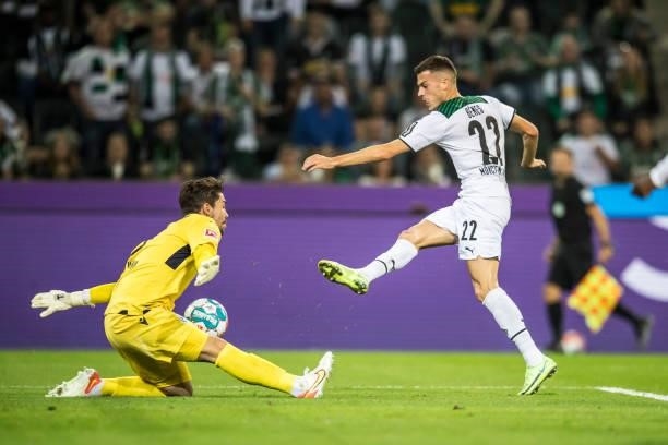 Laszlo Benes of Borussia Moenchengladbach and Stefan Ortega of Arminia Bielefeld in action during the Bundesliga match between Borussia...