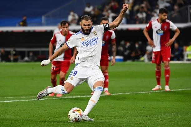 Real Madrid's French forward Karim Benzema shoots a penalty kick and scores his team's fifth goal during the Spanish League football match between...