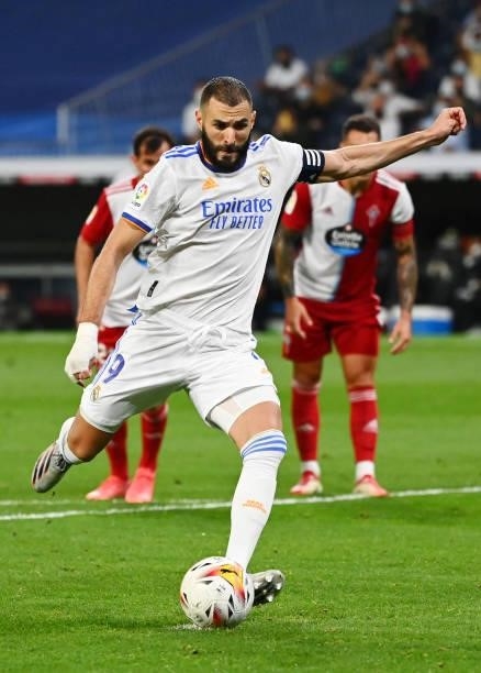 Real Madrid's French forward Karim Benzema shoots a penalty kick and scores his team's fifth goal during the Spanish League football match between...