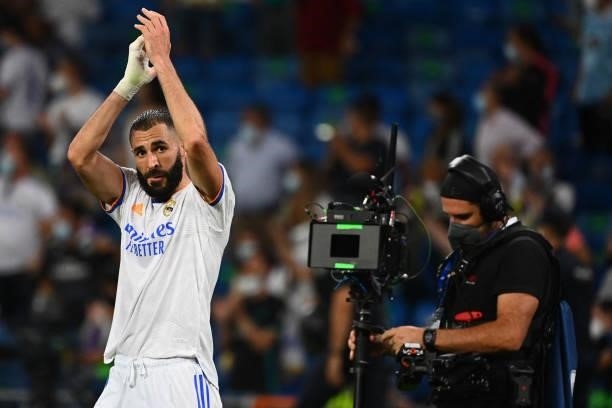 Real Madrid's French forward Karim Benzema celebrates his team's victory at the end of the Spanish League football match between Real Madrid CF and...