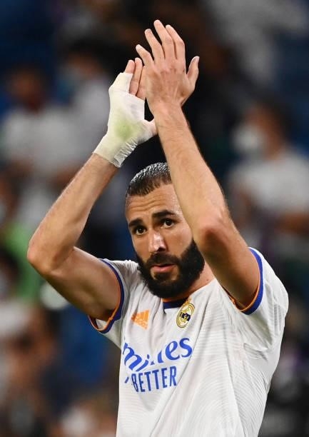 Real Madrid's French forward Karim Benzema celebrates his team's victory at the end of the Spanish League football match between Real Madrid CF and...