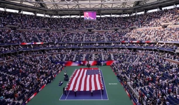 THe US flag is unfurled during opening ceremonies before the match between Serbia's Novak Djokovic and Russia's Daniil Medvedev during their 2021 US...
