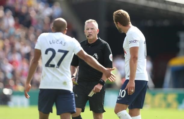 Tottenham Hotspur's Lucas Moura and Harry Kane appeal as referee Jonathan Moss gives Moura a yellow card during the Premier League match between...