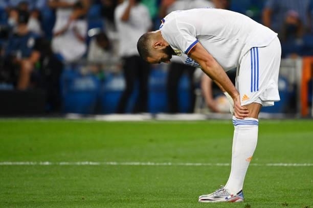 Real Madrid's French forward Karim Benzema bends over at the end of the Spanish League football match between Real Madrid CF and RC Celta de Vigo at...