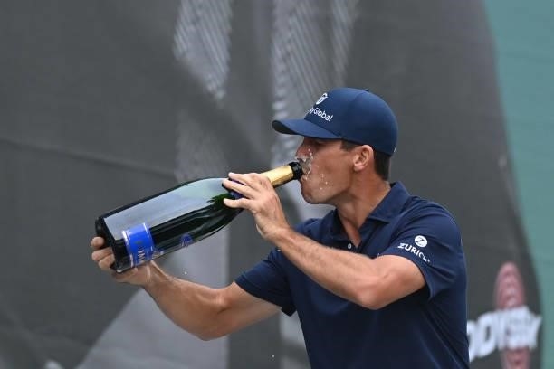 Golfer Billy Horschel drinks champagne as he celebrates his victory in the PGA Championship at Wentworth Golf Club in Surrey, south west of London on...