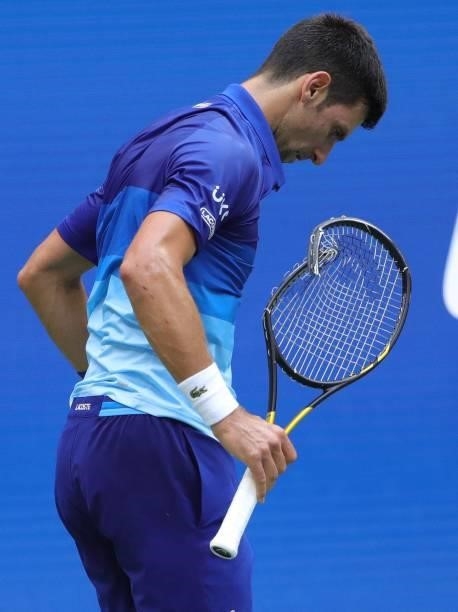 Novak Djokovic of Serbia smashes his racket in frustration while playing against Daniil Medvedev of Russia in the second set of the Men's Singles...