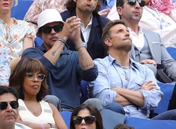 Actors Brad Pitt and Bradley Cooper watch the match between Serbia's Novak Djokovic and Russia's Daniil Medvedev during their 2021 US Open Tennis...