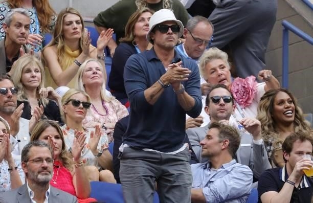 Actor Brad Pitt applauds as he watches the match between Serbia's Novak Djokovic and Russia's Daniil Medvedev during their 2021 US Open Tennis...