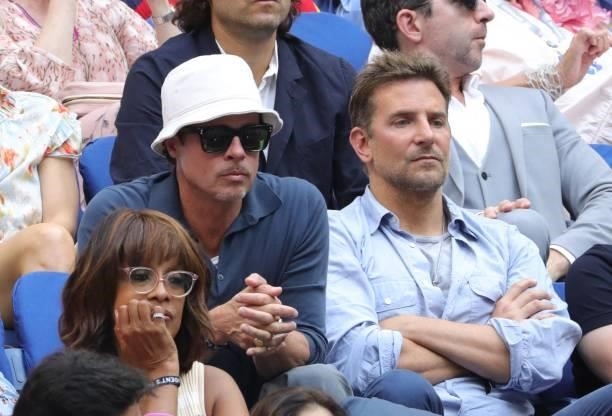 Actors Brad Pitt and Bradley Cooper watch the match between Serbia's Novak Djokovic and Russia's Daniil Medvedev during their 2021 US Open Tennis...