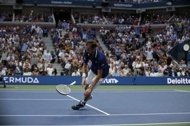 Russia's Daniil Medvedev drops to the ground in celebration of his win over Serbia's Novak Djokovic during their 2021 US Open Tennis tournament men's...
