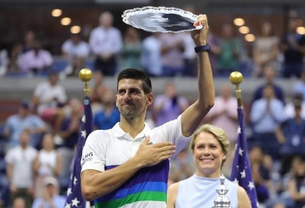 Serbia's Novak Djokovic holds his trophy after losing the 2021 US Open Tennis tournament men's final match against Russia's Daniil Medvedev and at...
