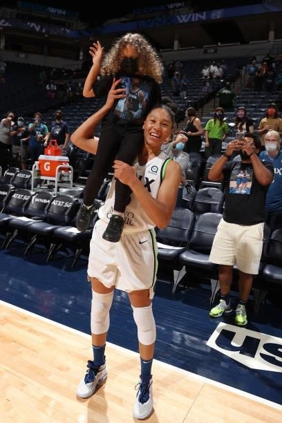 Aerial Powers of the Minnesota Lynx and poses for a picture with a fan after the game against the Indiana Fever on September 12, 2021 at Target...