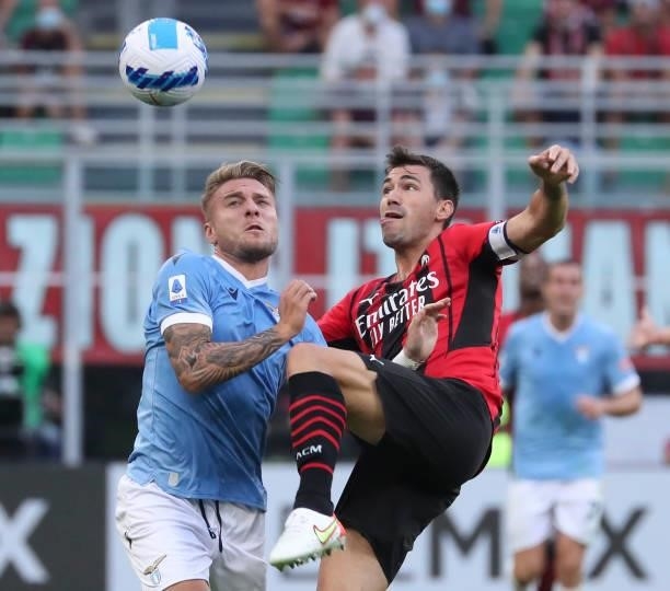 Ciro Immobile of SS Lazio competes for the ball with Alessio Romagnoli of AC Milan during the Serie A match between AC Milan and SS Lazio at Stadio...